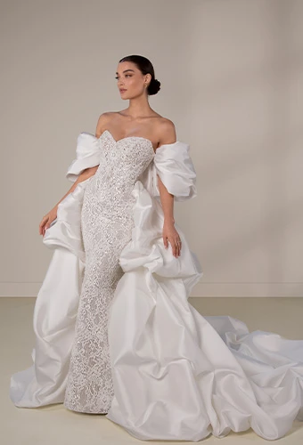 Bride wearing sparkling lace and mikado wedding dress with dramatic overskirt