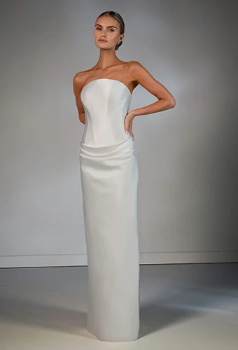 Bride wearing strapless sleek column wedding dress with internal corset 