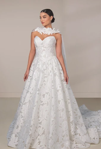 Bride wearing strapless wedding dress with all over graphic lace and sweetheart neckline