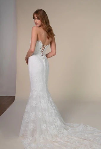 Bride wearing lace wedding dress with long sleeves and lace up back