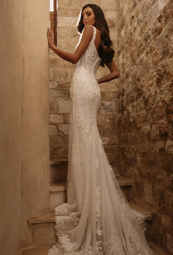 Bride wearing beaded lace fit-and-flare wedding dress with straps