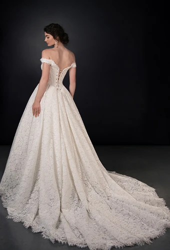 Bride wearing lace ballgown wedding dress with basque waist and off-the-shoulder straps