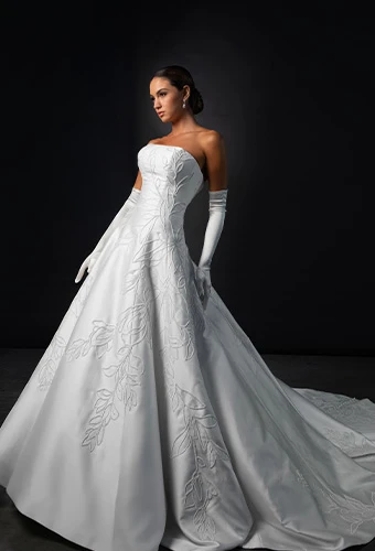 Bride wearing strapless wedding dress with straight across neckline and optional gloves