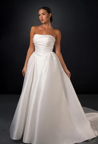 Bride wearing strapless silk ballgown with pleated bodice and straight across necline