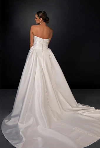 Bride wearing strapless silk ballgown with pleated bodice and straight across necline