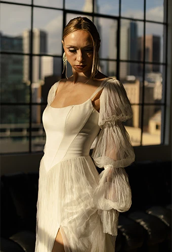 Bride wearing boho wedding dress with statement sleeves