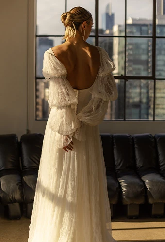 Bride wearing boho wedding dress with statement sleeves