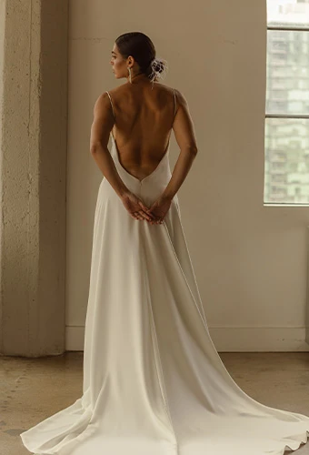 Bride wearing simple wedding dress with open back