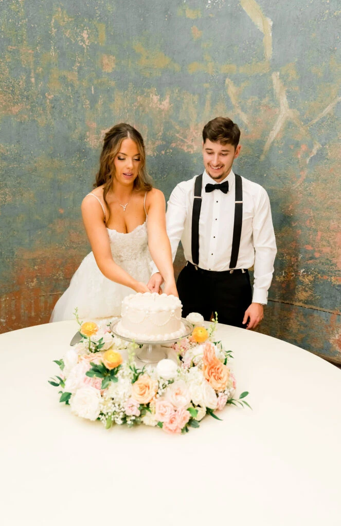 Real bride Janet cutting her wedding cake with her husband