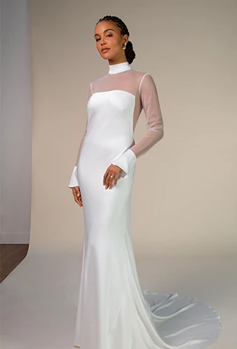 Bride wearing simple crepe wedding gown with high neckline and sheer long sleeves
