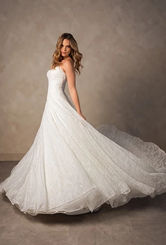 Bride wearing strapless ballgown wedding dress with scoop neckline and allover lace