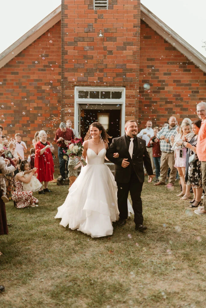Real Stella York Bride Holly and Michael celebrating after their ceremony