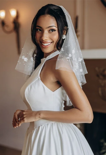 Bride wearing simple high neck wedding dress with fabric-covered buttons