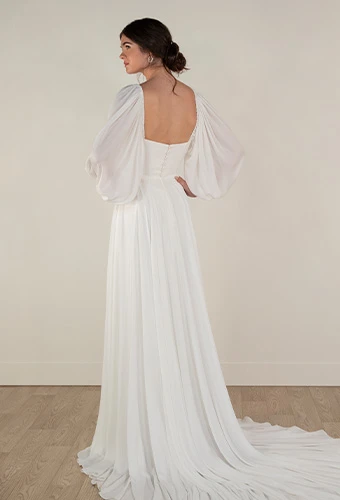 Bride wearing simple a line wedding dress with long blouson sleeves