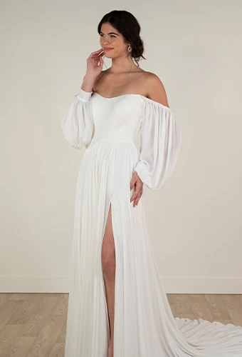 Bride wearing simple a line wedding dress with high leg slit, sweetheart neckline and off the shoulder blouson sleeves