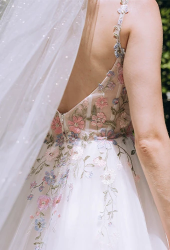 Bride wearing colorful a line wedding dress with floral lace, v back and spaghetti straps