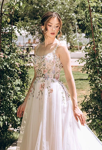 Bride wearing colorful a line wedding dress with floral lace and spaghetti straps