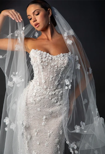 Close up of bride wearing strapless fit-and-flare 3D floral lace and tulle wedding gown