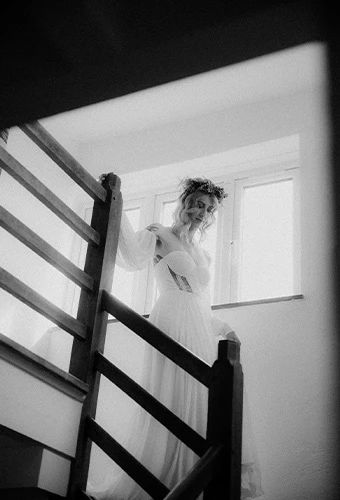 Real All Who Wander bride Georgie walking down the stairs on her wedding day
