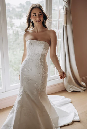 Bride in a gorgeous white mermaid wedding dress with an ornate beaded bodice, shot in natural window light