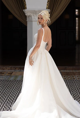 Bride wearing ballgown wedding dress with square neckline and straps
