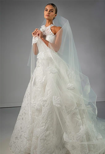 Bride wearing graphic lace wedding dress with halter neckline