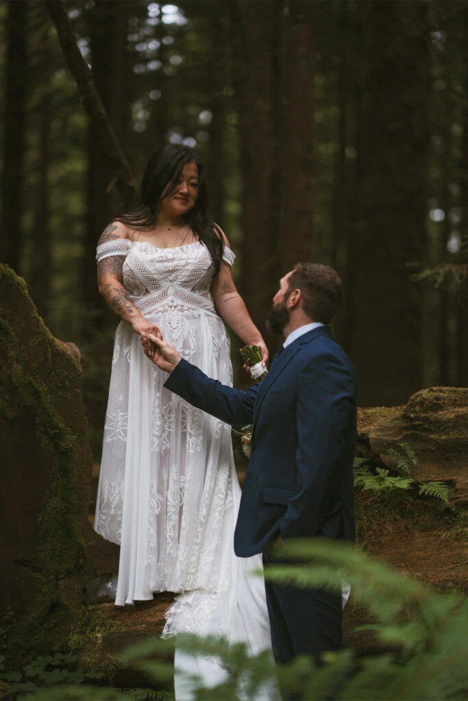 Real Bride Teresa and Eric holding each others hands at the Redwood National Park