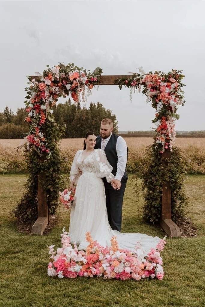 Real bride Kylie posing with her husband at the altar