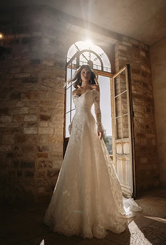 Bride wearing off-the-shoulder long sleeve a-line wedding dress with allover lace, Martina Liana ML2072