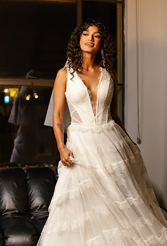 Bride wearing boho lace and tulle a-line wedding gown with tiered skirt, All Who Wander gray