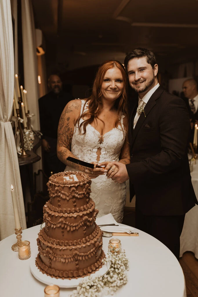 Real bride Mackenzie and her husband cutting their wedding cake