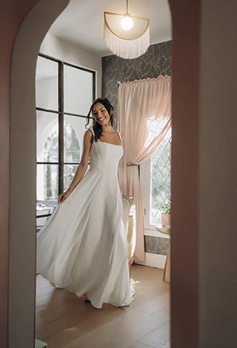 Bride wearing structural a-line wedding gown with square neckline and wide straps, Stella York SY8257