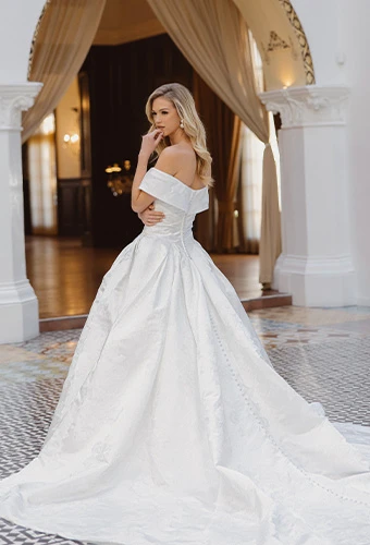 Bride wearing jacquard ballgown wedding dress with off-the-shoulder straps