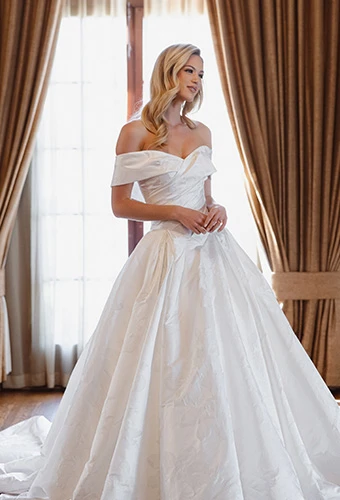 Bride wearing jacquard ballgown wedding dress with off-the-shoulder straps