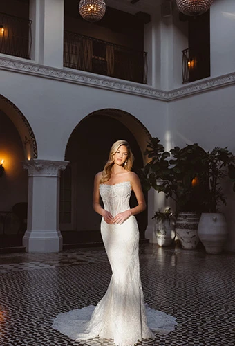 Bride wearing strapless fit-and-flare wedding dress with lace and sheer corset, Essense of Australia D4541