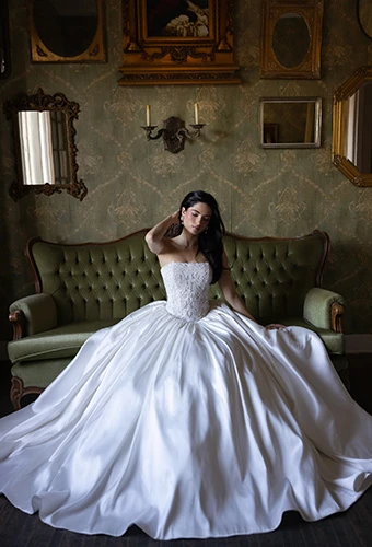 Bride sitting wearing strapless silk ballgown with beaded bodice, Essense of Australia D4546