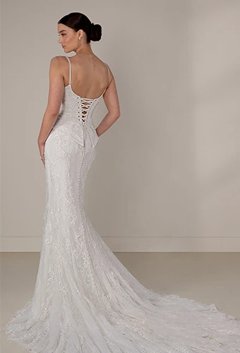 Bride wearing sparkling lace wedding dress with lace up back and thin spaghetti straps