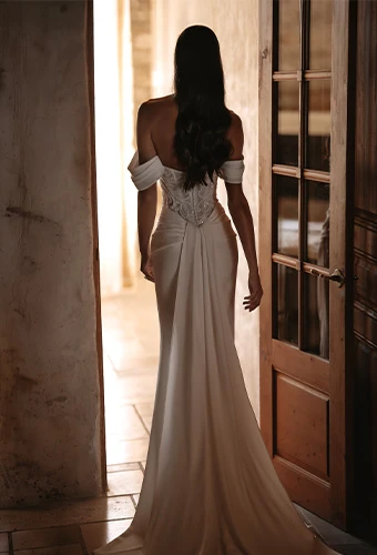 Bride wearing column wedding dress with sparkling lace bodice and off the shoulder straps
