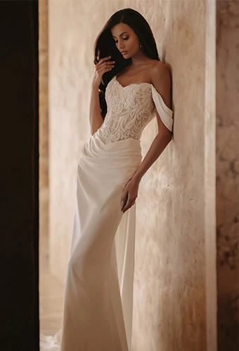 Bride wearing column wedding dress with sparkling lace bodice, sweetheart neckline and off the shoulder straps