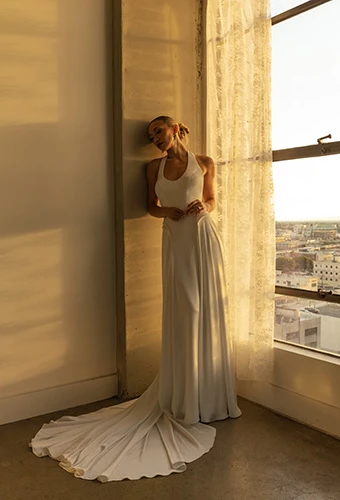 Bride wearing charmeuse wedding gown with peplum basque waist and scoop neckline, All Who Wander jovi