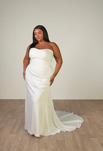 Plus size bride wearing sculptural satin column wedding dress, Stella York SY8347+