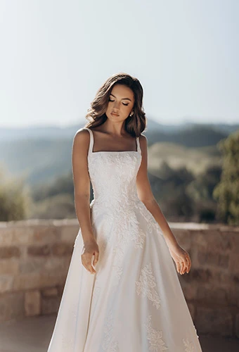 Bride wearing a-line wedding dress with square neckline, thick straps and floral appliques, Martina Liana ML2036