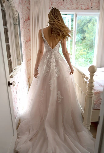 Bride wearing lace wedding dress with open v-back and shoulder straps