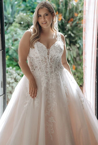 Bride wearing tulle and lace a-line wedding gown with floral details and plunging neckline, Stella York SY8314