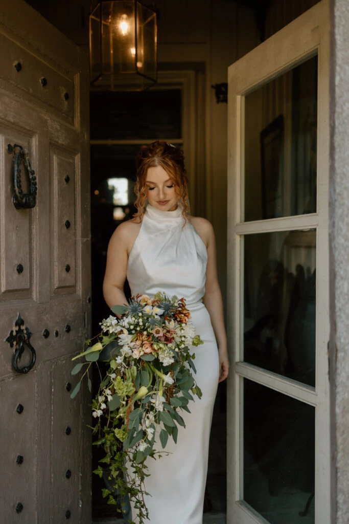 Real bride Savannah in her wedding gown with a large bouquet