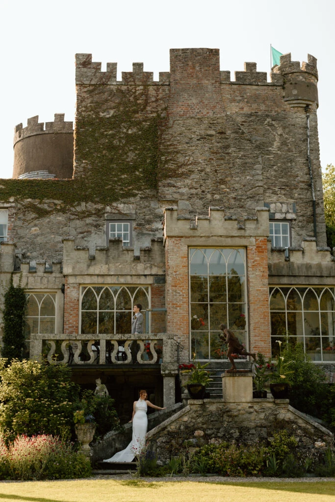 Real bride Savannah posing with her husband in front of an Irish castle
