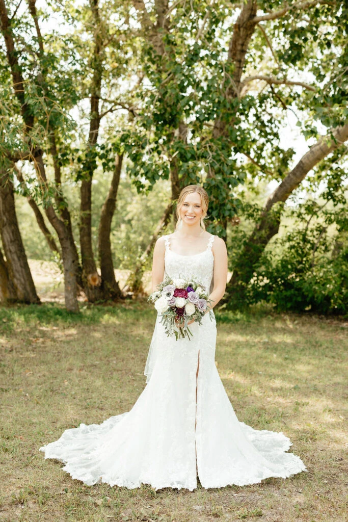 Real bride posing in her wedding gown with bouquet