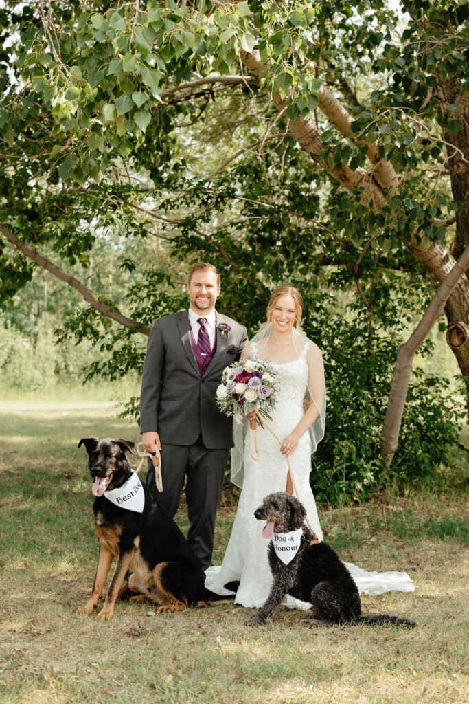 Real bride Kara posing with her husband and her dogs