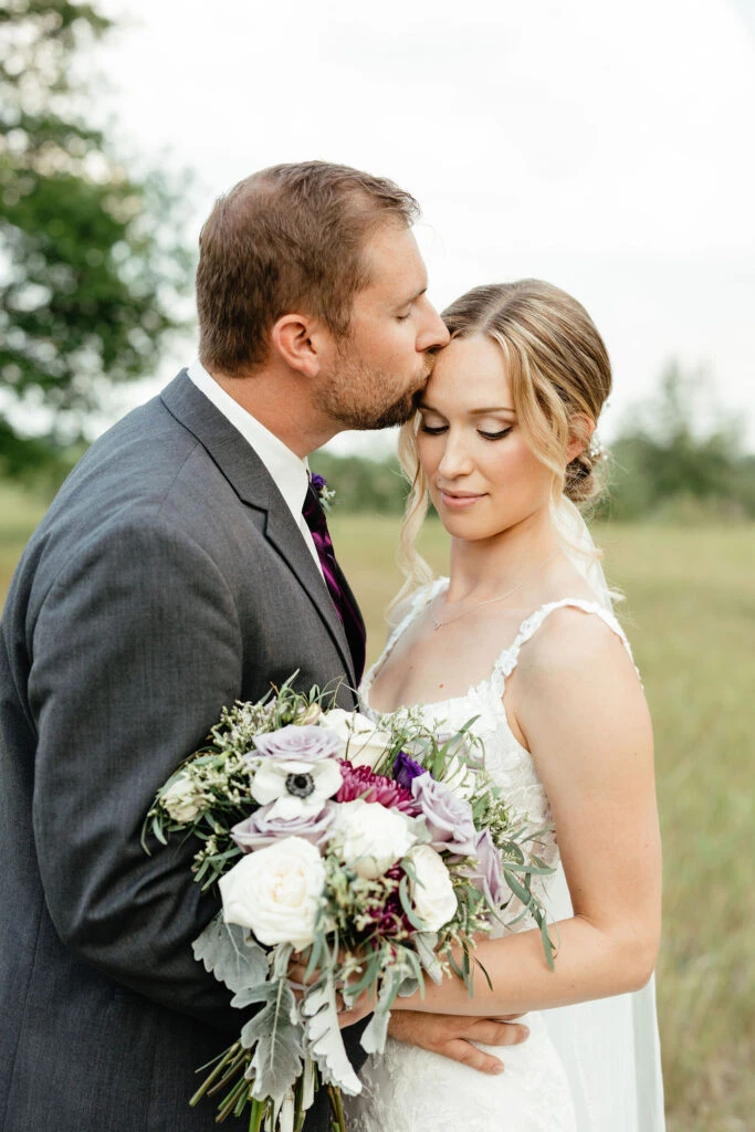 True bride Kara posing lovingly with her husband