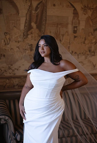 Plus size bride wearing crepe wedding dress with asymmetrical ruching, Essense of Australia D4563+